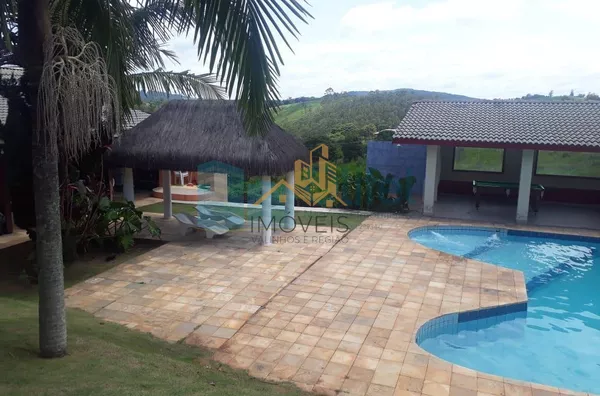 Chácara Paradisíaca! Bairro tranquilo de chácaras residenciais. Rua Asfaltada e próximo a rodovia. Possui salão para festas próximo a piscina, quiosque, sala de jogos, campo de futebol, casa de caseiro. Casa Principal: Toda avarandada com 03 quartos, sala - Foto 5