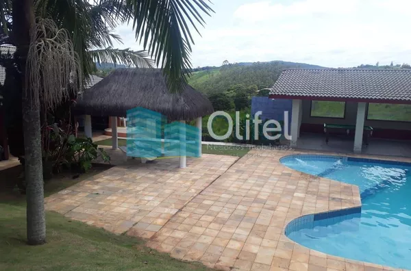 Chácara Paradisíaca! Bairro tranquilo de chácaras residenciais. Rua Asfaltada e próximo a rodovia. Possui salão para festas próximo a piscina, quiosque, sala de jogos, campo de futebol, casa de caseiro. Casa Principal: Toda avarandada com 03 quartos, sala - Foto 5