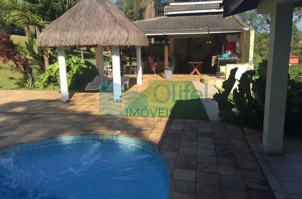 Chácara Paradisíaca! Bairro tranquilo de chácaras residenciais. Rua Asfaltada e próximo a rodovia. Possui salão para festas próximo a piscina, quiosque, sala de jogos, campo de futebol, casa de caseiro. Casa Principal: Toda avarandada com 03 quartos, sala - Foto 7